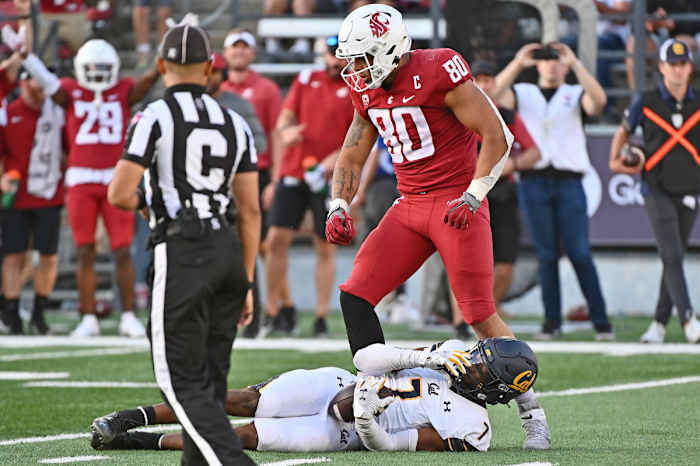 Washington State Cougars defensive end Brennan Jackson (80) celebrates after a tackle.